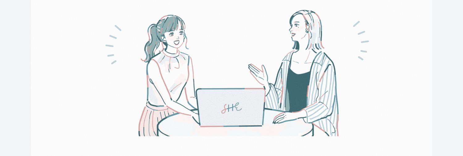 SHEのロゴ入りノートPCを挟んで向かい合い、笑顔で会話する2人の女性のイラスト