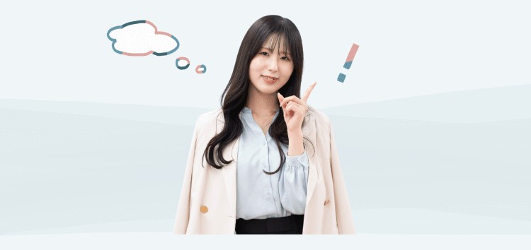 微笑みながら人差し指を立てるKaorukoさん。左に思考中を示す吹き出し状のアイコン、右に感嘆符のアイコン